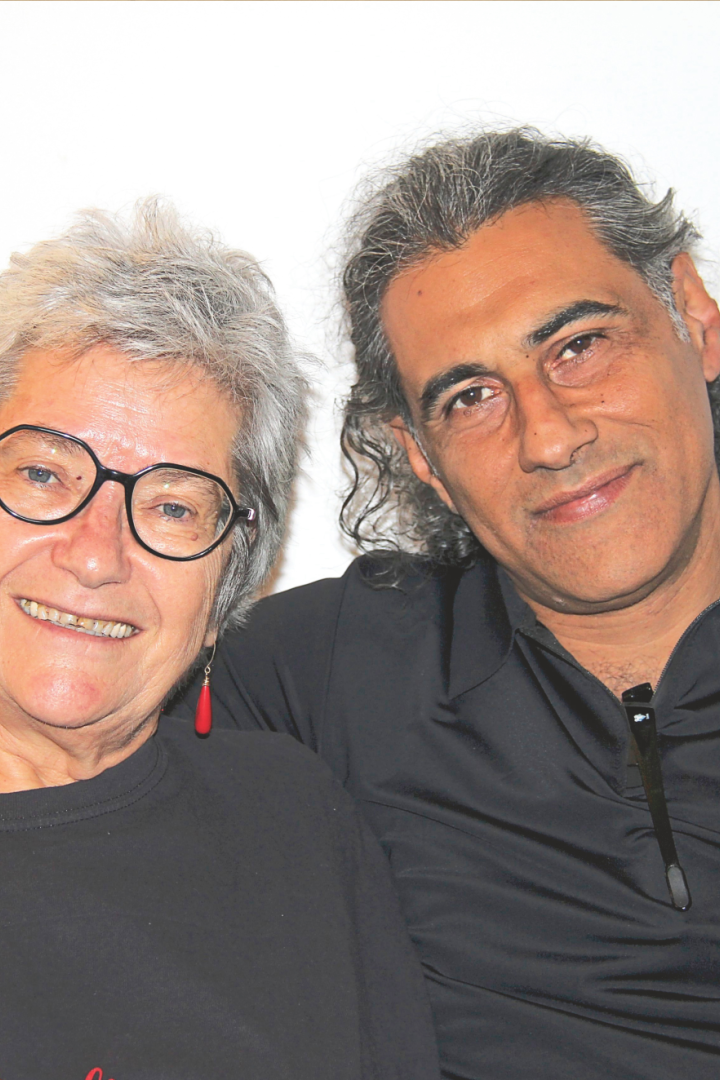 Ruti Katz und Osama Zater sitzen lächelnd auf einer Couch