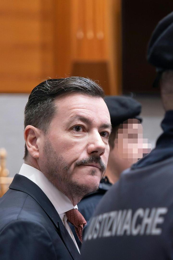 René Benko beim Prozess – flankiert von Justizwachebeamten