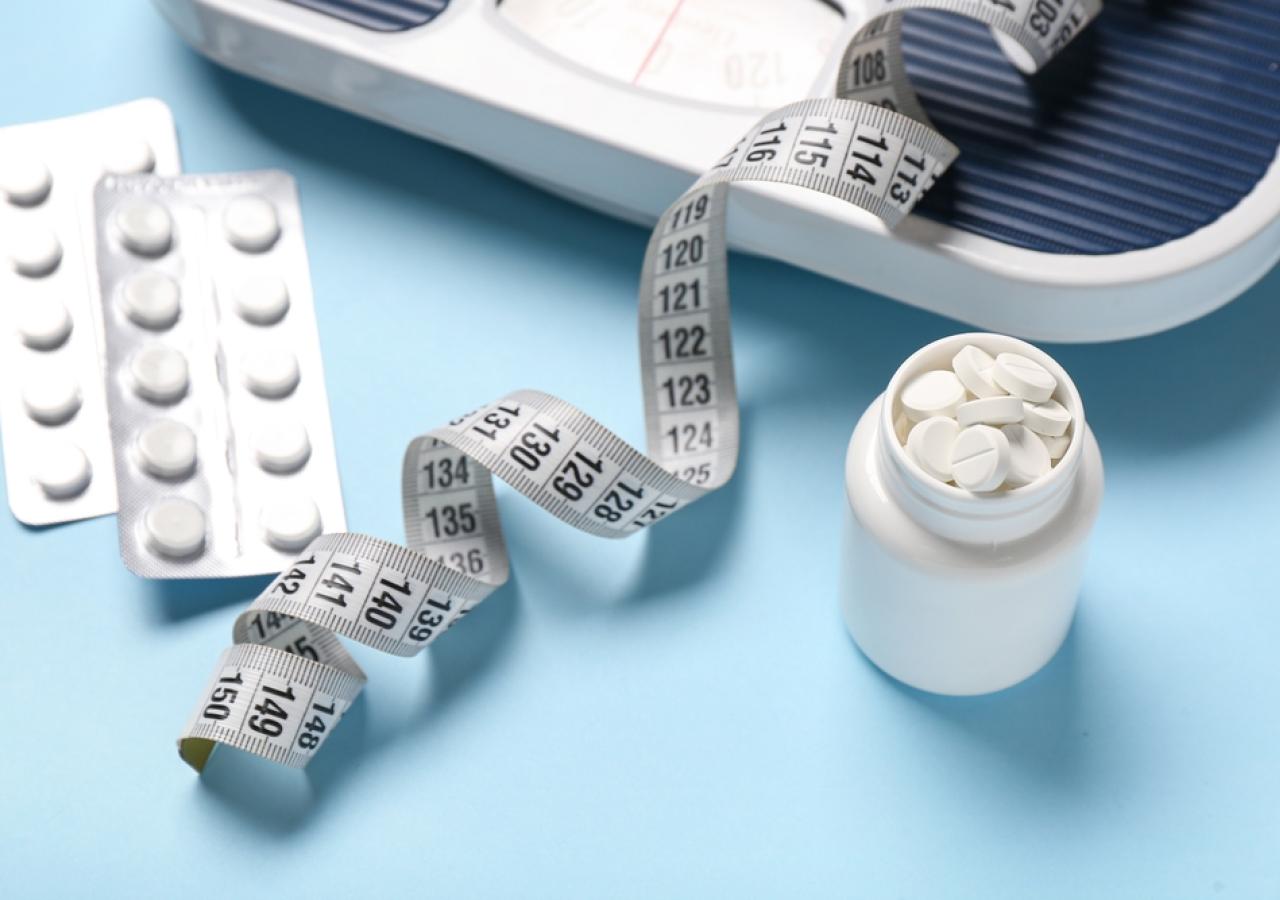 Stillleben aus Tabletten, Maßband, Waage