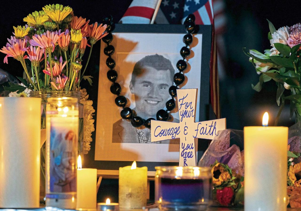 Candles and flowers are seen near a portrait of right-wing activist Charlie Kirk at a makeshift memorial during a candlelight vigil at Memorial Park in Provo, Utah,