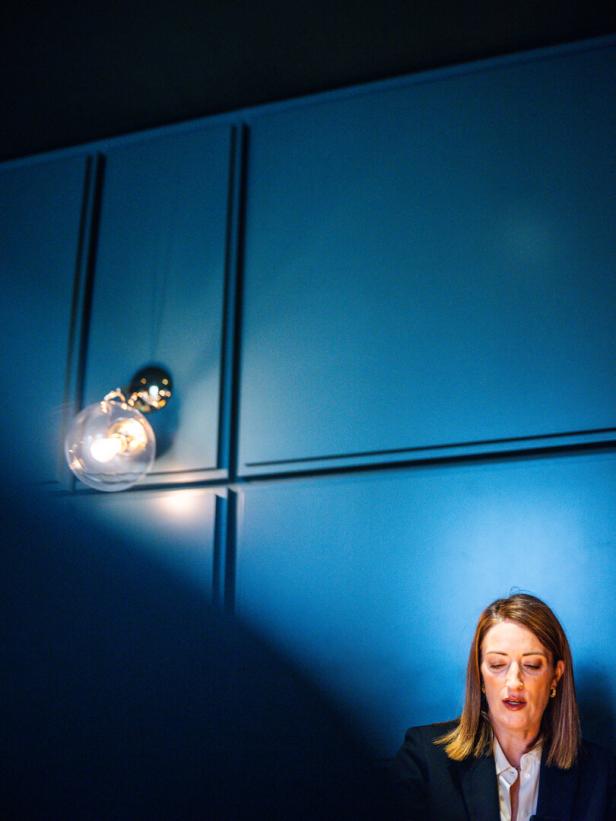 Roberta Metsola vor einer blauen Wand.
