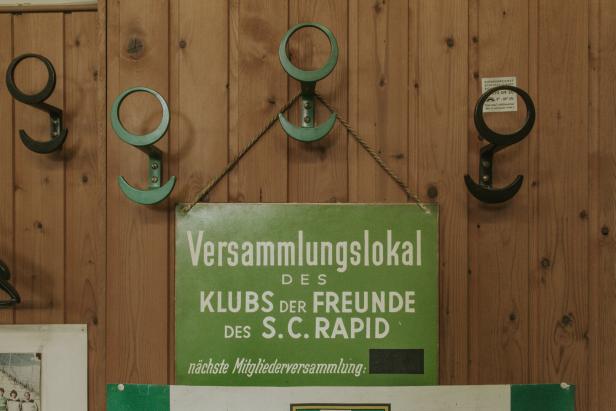 Schild des Klubs der Freunde des SC Rapid hängt an einer holzvertäfelten Wand