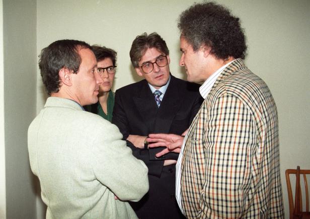 Vier Personen stehen eng beieinander und führen ein intensives Gespräch in einem Raum. Es handelt sich um die Grünpolitiker Grünpolitiker Peter Pilz, Terezija Stoisits, Pius Strobl und Andreas Wabl im Jahr 1993.
