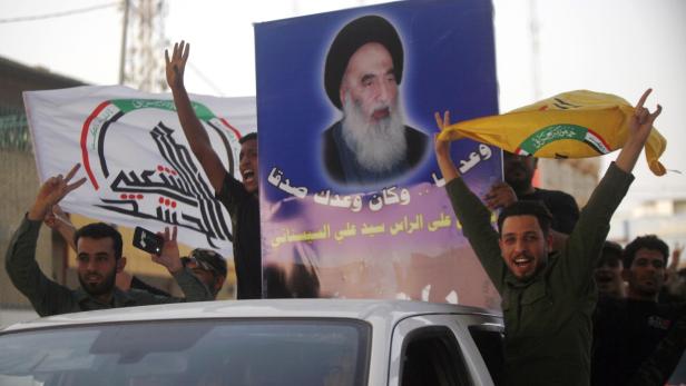 Irakis feiern den Sieg in Mossul (mit einem Porträt des schiitischen Klerikers Ali al-Sistani).