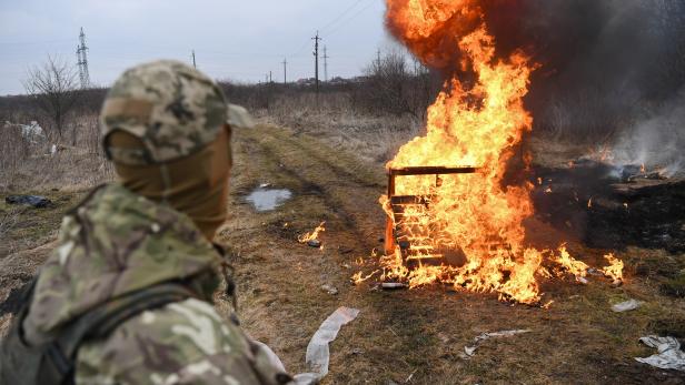 Ein ukrainischer Soldat blickt auf Flammen, nachdem er während eines Selbstverteidigungskurses für Zivilisten am 4. März 2022 am Stadtrand von Lemberg (Westukraine) einen Molotow-Cocktail geworfen hat.