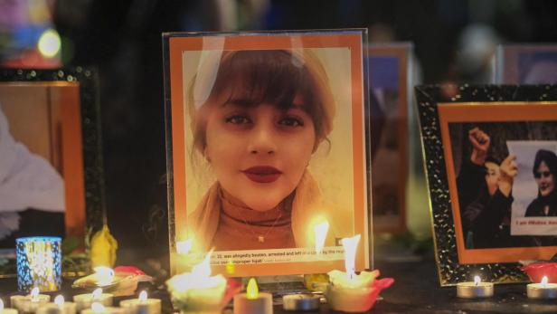 Ein Foto von Mahsa Amini, umgeben von Kerzen, als Zeichen des Gedenkens.