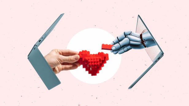 Eine menschliche und eine Roboterhand reichen aus Laptops heraus und greifen nach einem Herz
