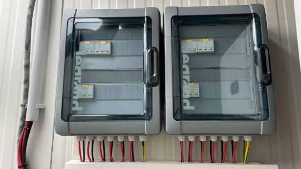 Zwei elektrische Schaltschränke mit Sicherungen und Kabeln.