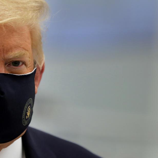 FILE PHOTO: U.S. President Donald Trump wears a protective face mask during a tour of the Fujifilm Diosynth Biotechnologies' Innovation Center, in Morrisville