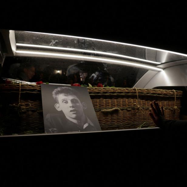 A view of a hearse carrying the coffin of late Irish singer Shane MacGowan during his funeral procession, as fans line the street to say their last goodbye to him, in Tipperary, Ireland, December 8, 2023. REUTERS/Karen Cox