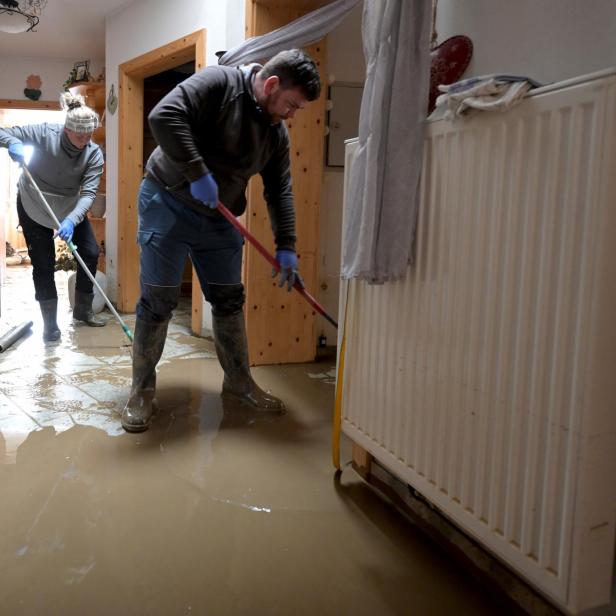 Paar kehrt Wasser nach dem Hochwasser