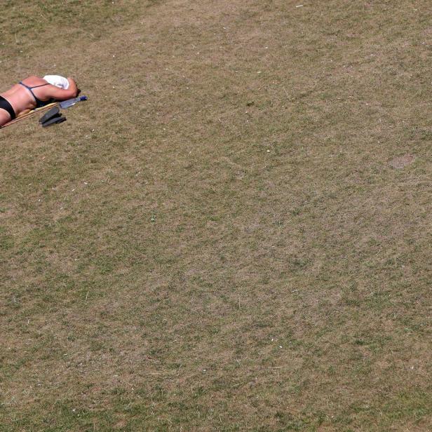 person mit sonnenbrand auf trockenem gras