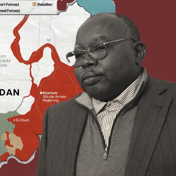 Ein Mann (Abdul Wahid al-Nur) steht vor einer Karte des Sudan.