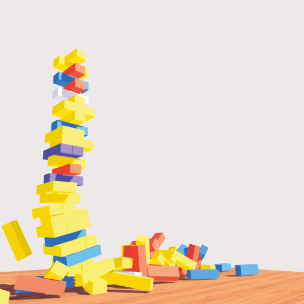 Mehrfarbige Bauklötze in Gelb, Blau und Rot fallen auf einen Holzboden, einige Klötze sind gestapelt, andere liegen verstreut.