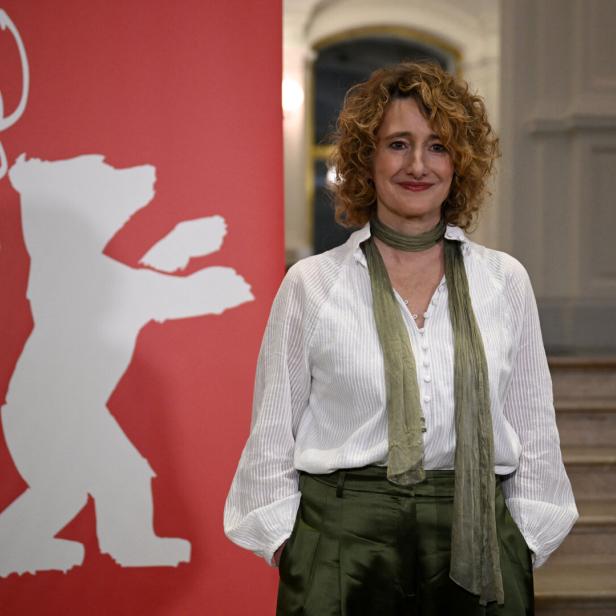 Berlinale-Chefin Tricia Tuttle posiert neben dem Bären-Logo ihres Festivals