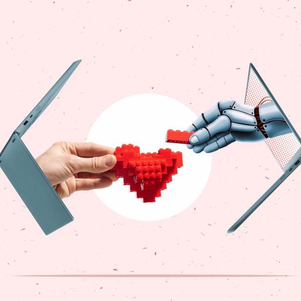 Eine menschliche und eine Roboterhand reichen aus Laptops heraus und greifen nach einem Herz